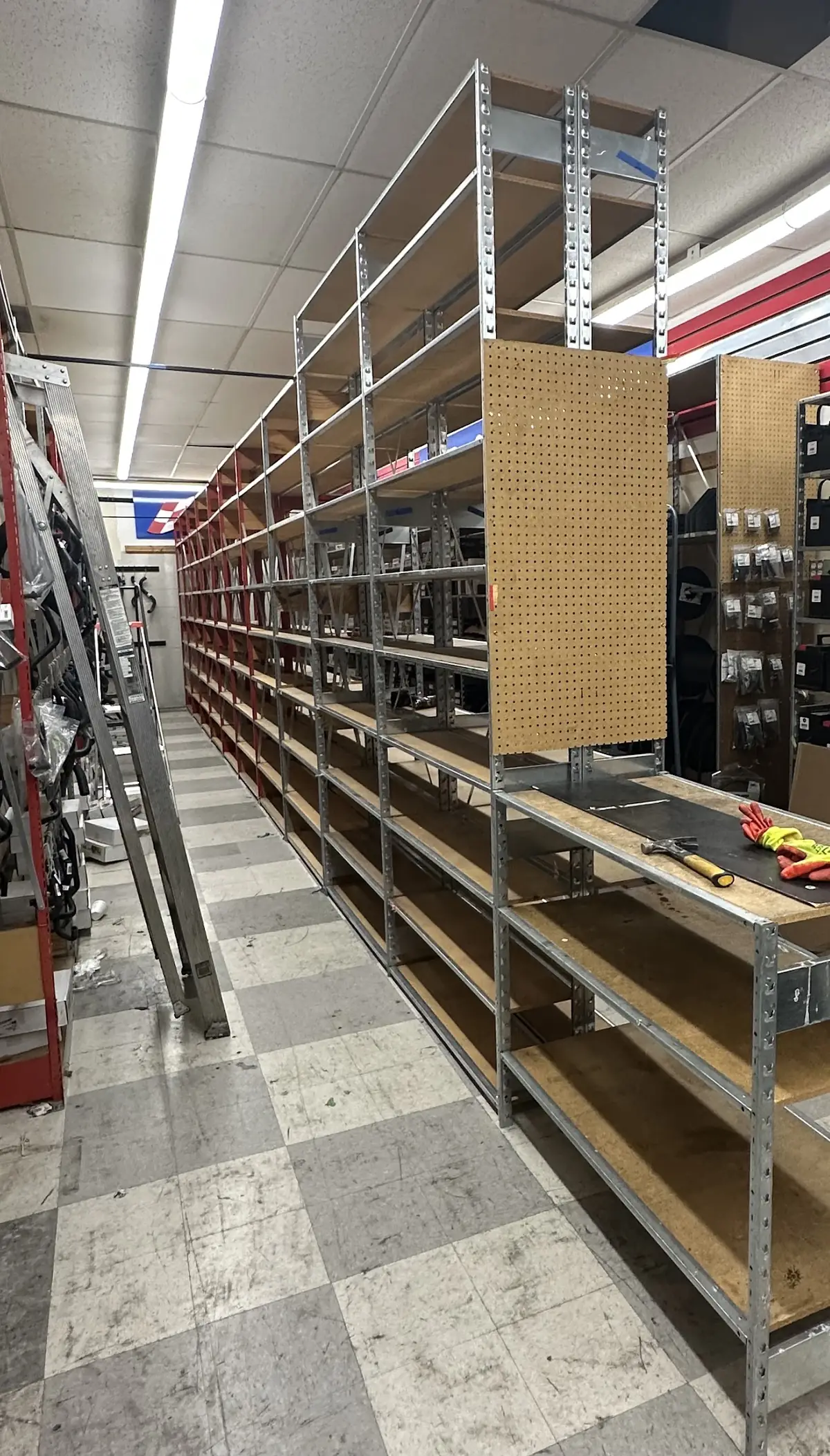Steel shelving and pegboard bays installed in a retail store