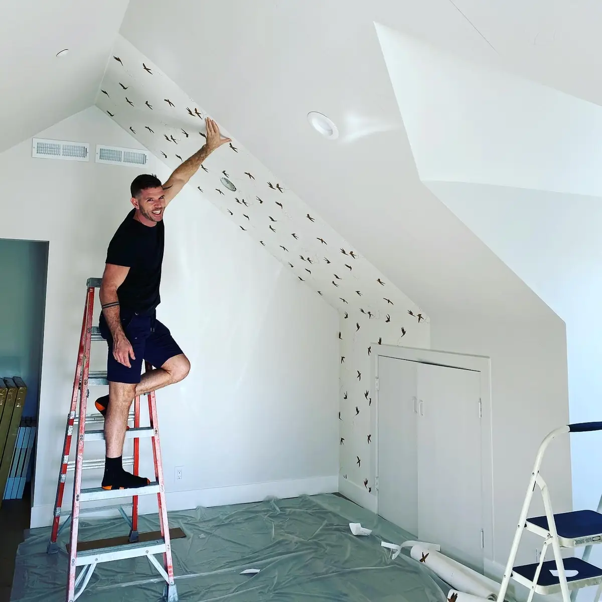Internal Maintenance hanging wallpaper on a vaulted ceiling in a Los Angeles home
