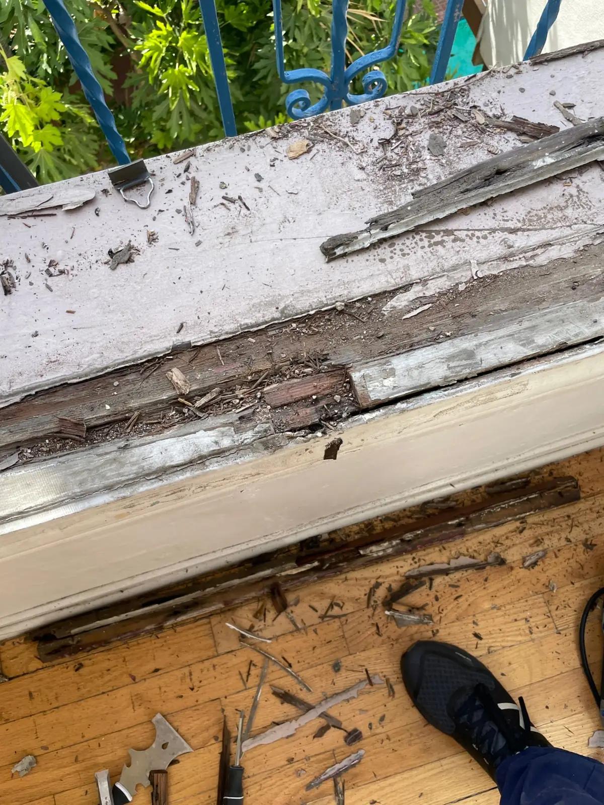Window sill with rotten wood and peeling paint exposed